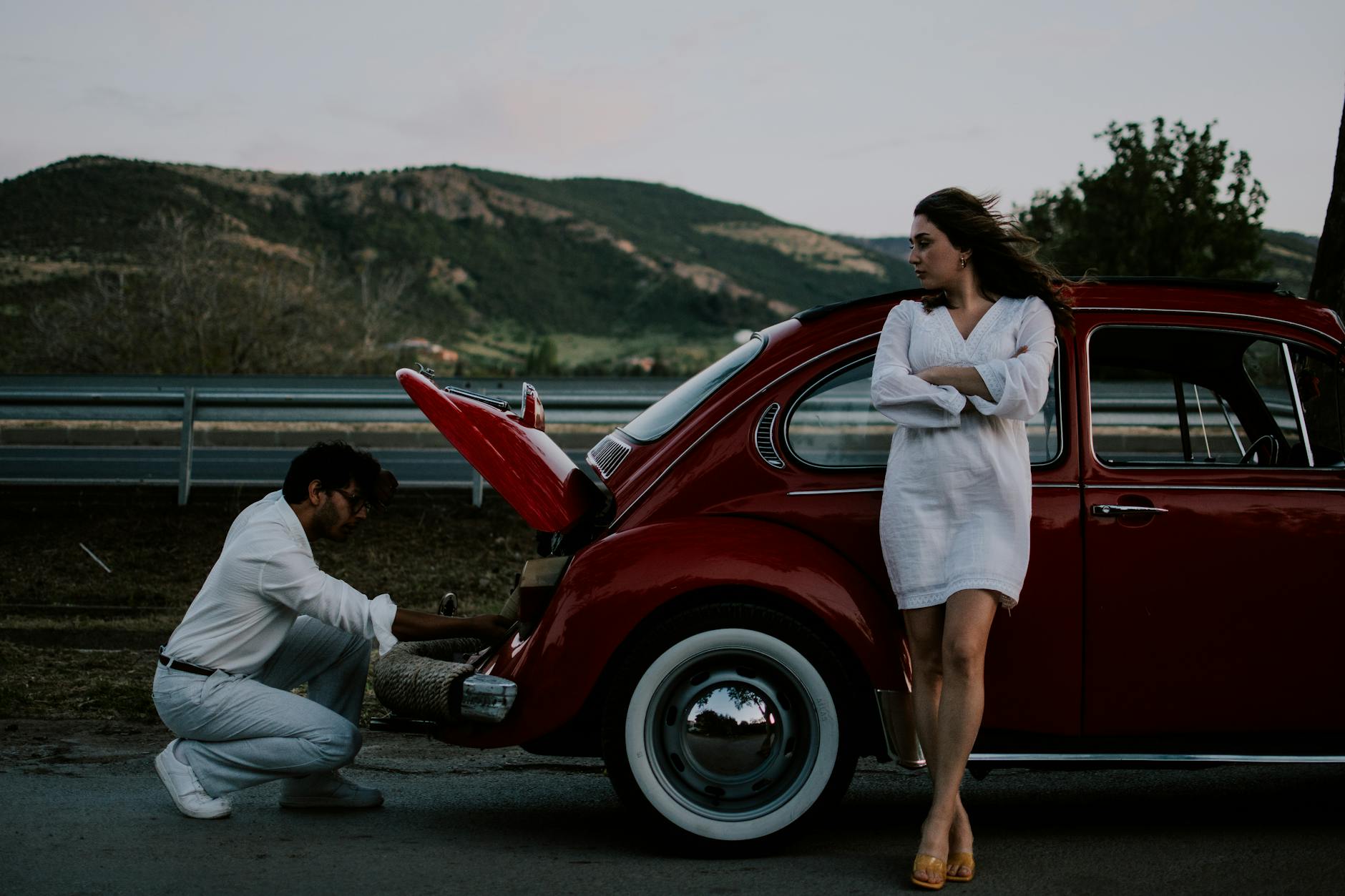 man and woman with vintage volkswagen beetle